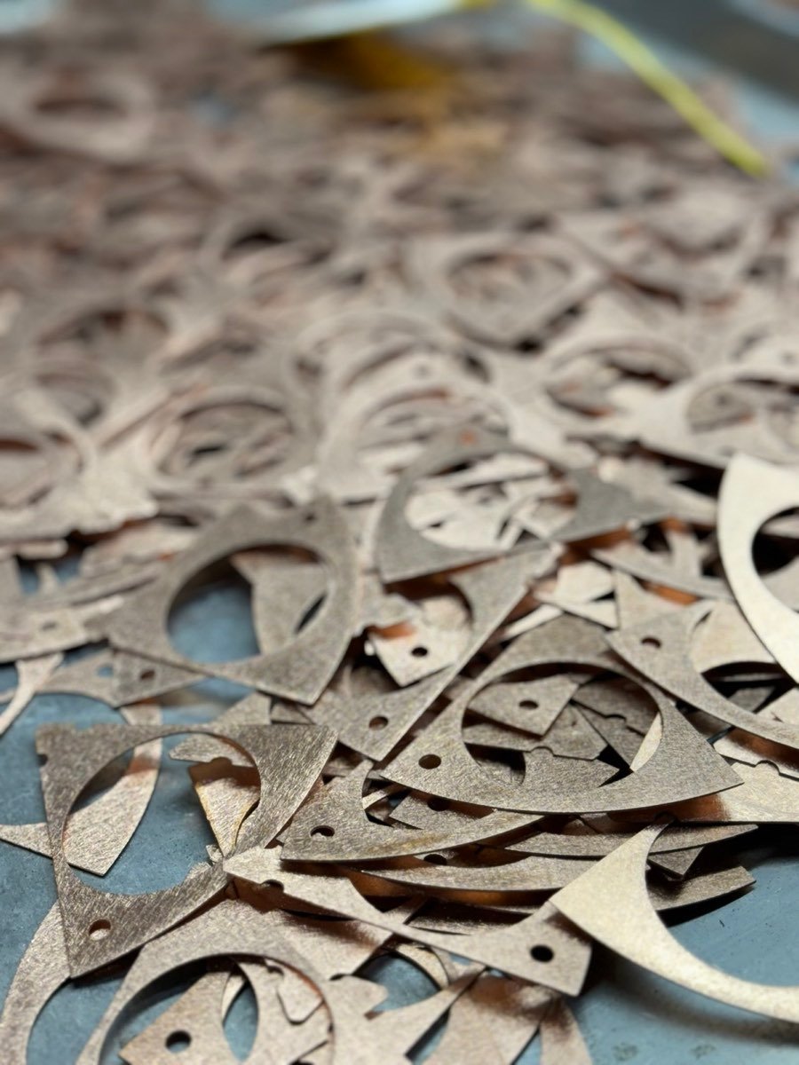 Batch of waterjet-cut parts for industrial equipment